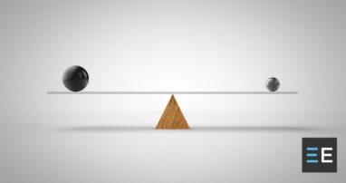 A balance leveled between a small sphere and a larger sphere