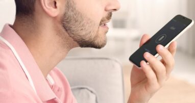 A person speaking into their smartphone